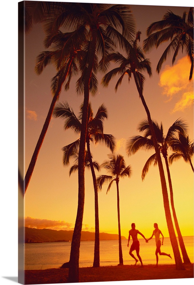 Couple Runs Together Holding Hands Under Palm Trees At Sunset