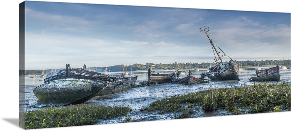 Derelict boats in a graveyard on the mud at Pin Mill.