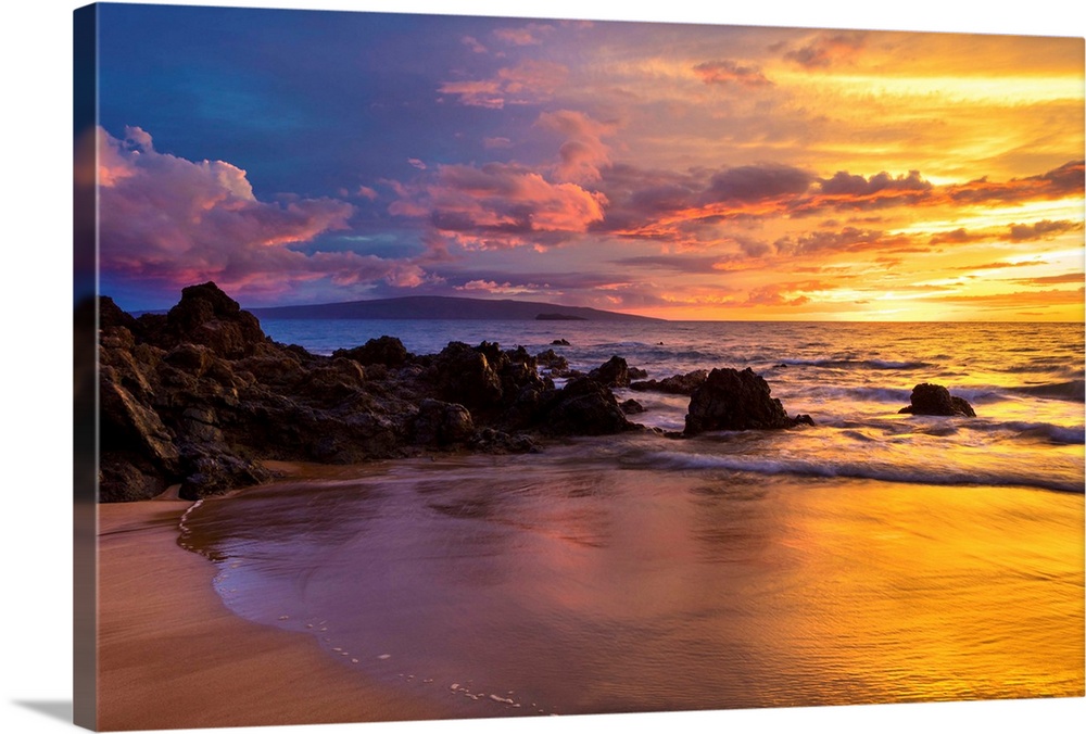 Dramatic clouds during a sunset on a beach; Makena, Maui, Hawaii, United States of America.