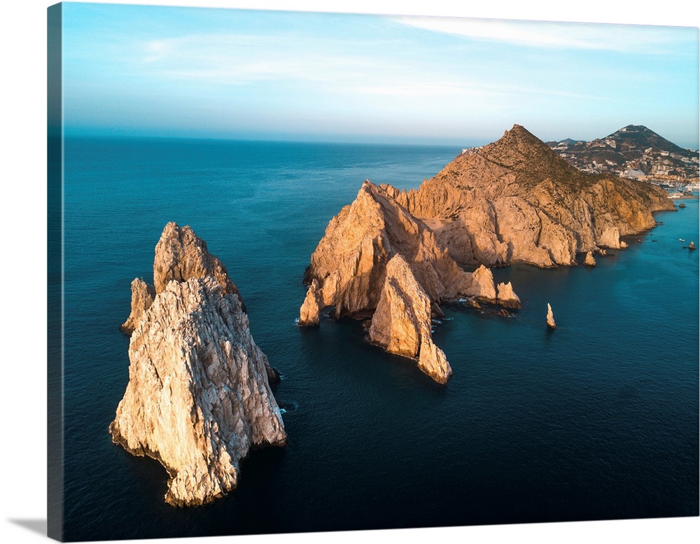 Dramatic rock formations on the southern tip of the Baja Peninsula called Lands End from the air at sunset with the resort...
