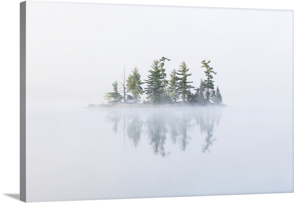 Fog shrouds a small island on Turtle Lake in Ontarios Muskoka Region, near Rosseau; Ontario, Canada