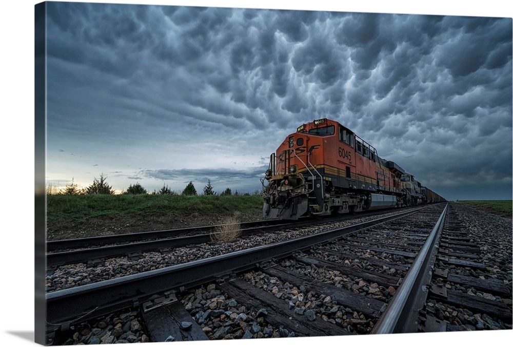 Freight train with mammatus clouds overhead while on a storm chasing tour; Oklahoma, United States of America.