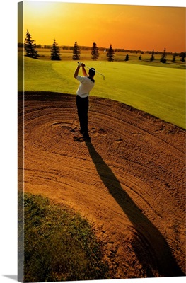 Golfer Taking A Swing From A Golf Bunker