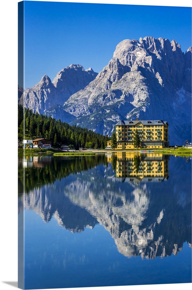 Grand Hotel Misurina reflected in Lake Misurina on a sunny day in the Dolomites in Veneto, Italy