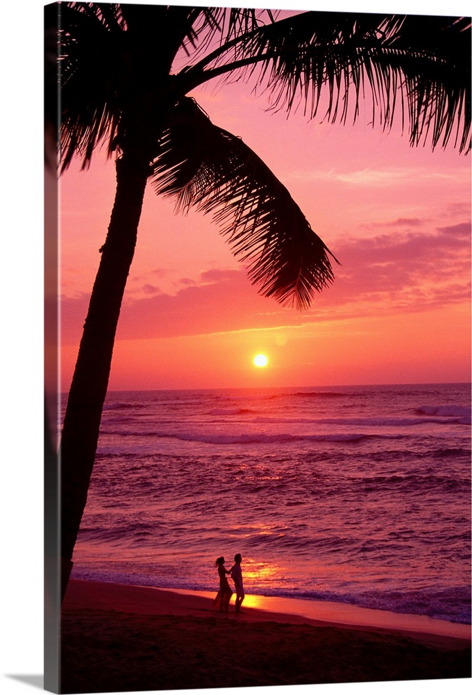 Hawaii, Couple Silhouetted On The Beach At Sunset With Tall Palm Foreground