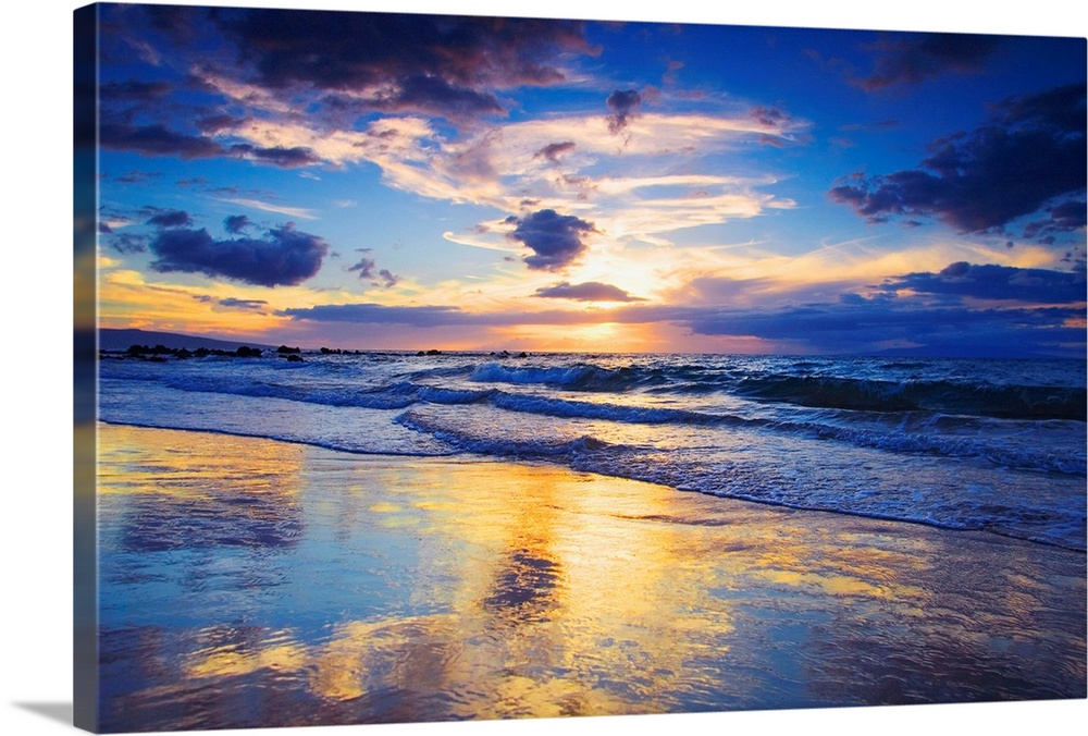 Horizontal photograph on a large wall hanging of a vivid sunset glowing through clouds, over the shore of Mokapu Beach in ...
