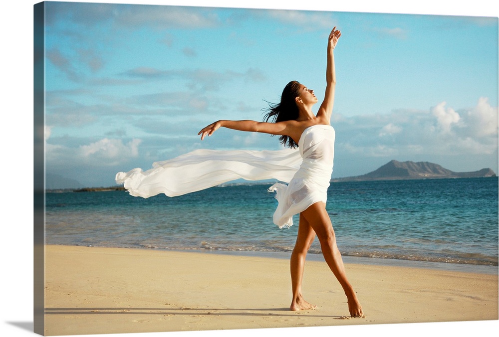 Big canvas of a woman with a white sheets wrapped around her poses on a Hawaiian beach.