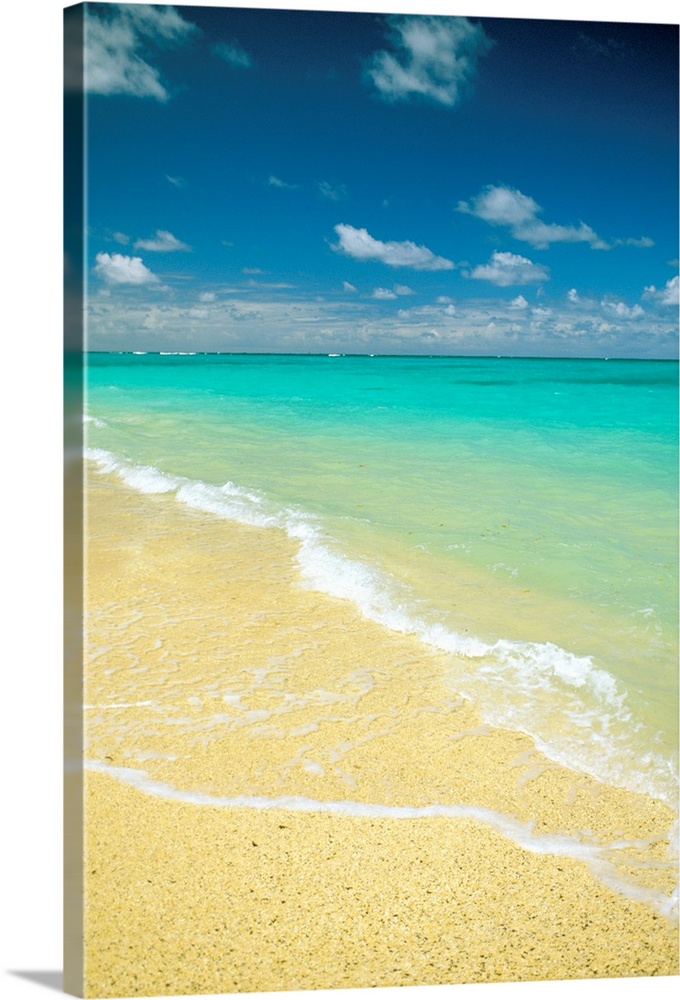 Vertical photo on canvas of crystal clear waves washing up on shore of a beach.