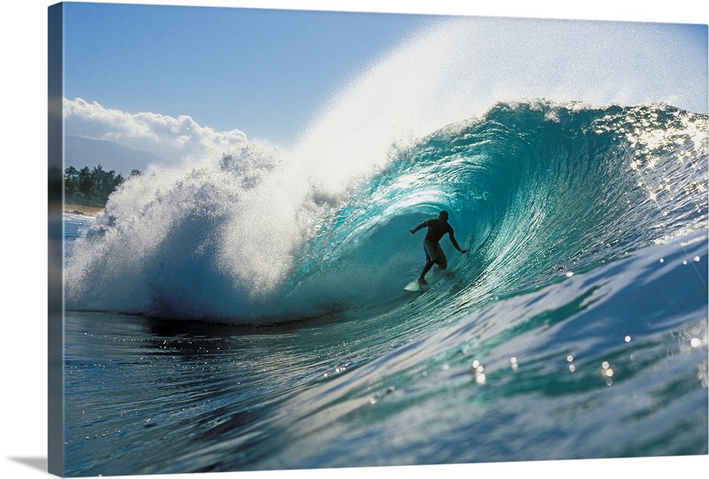 Oversized, landscape photograph of a surfer riding down the center of Pipeline Wave, in the blue waters of North Shore, Oa...