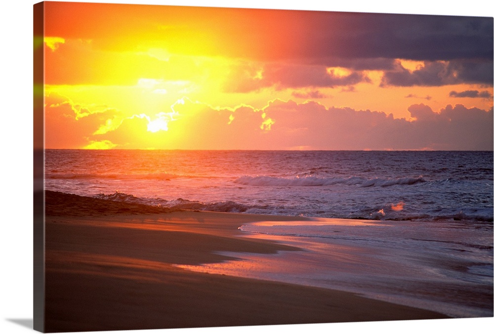 Big canvas print of waves crashing on to a beach with the sun rising in the background.