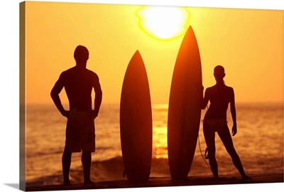 Hawaii, Oahu, Silhouette Of Man And Woman On Beach With Surfboards At Sunset