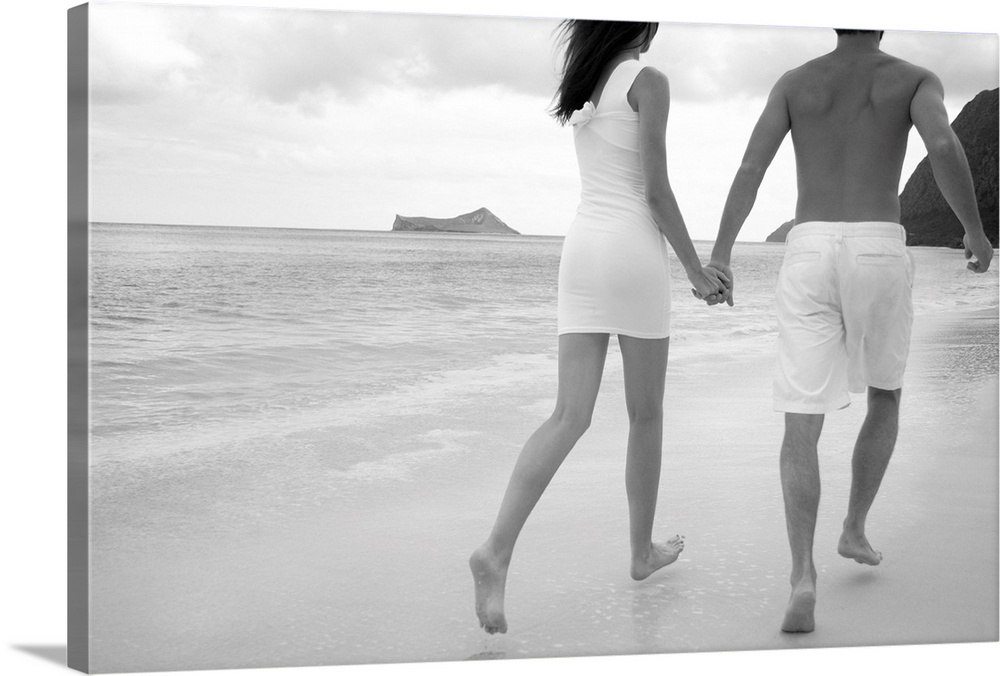 Hawaii, Oahu, Waimanalo, Young Couple Holding Hands Running Together Along The Beach