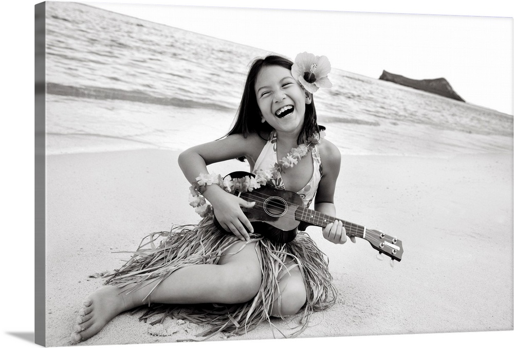 Hawaii, Oahu, Young Girl Smiling And Playing Ukulele On The Beach In A Hula Skirt