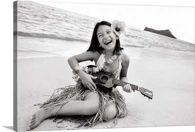Hawaii, Oahu, Young Girl Smiling And Playing Ukulele On The Beach In A Hula Skirt