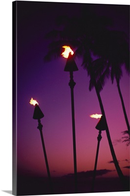 Hawaii, Tiki Torches Lit At Twilight, Purple Skies, Palm Trees