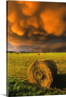 Haybale And Storm Clouds; Alberta, Canada