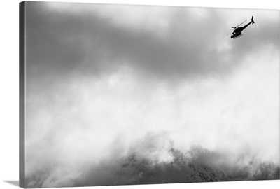 Heli ski helicopter flying amongst fog and clouds, New Zealand