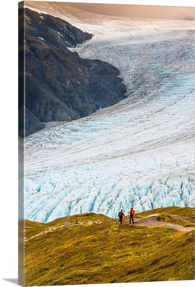 A man and woman hiking down the Harding Icefield Trail with Exit Glacier in the background, Kenai Fjords National Park, Ke...