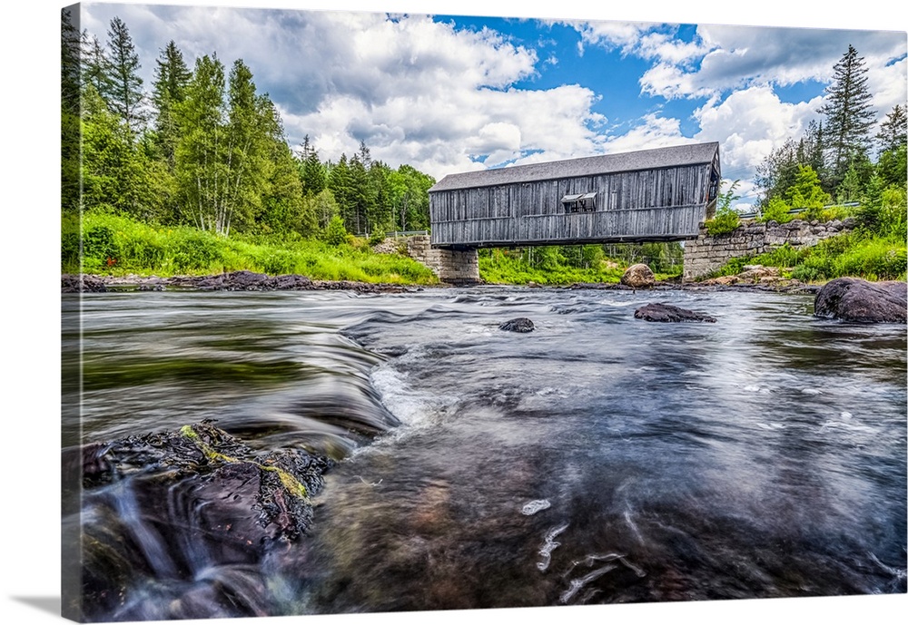 Historic covered bridge over a shallow stream; Saint John, New Brunswick, Canada