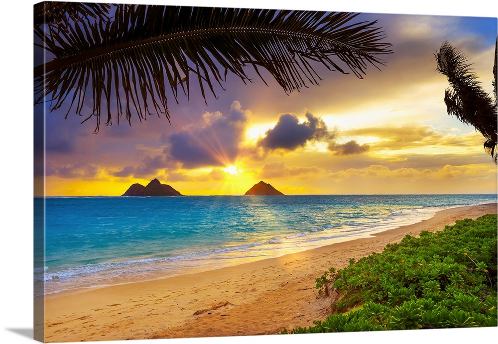 Sunrise viewed from Lanikai Beach with a view of the Mokulua Islands off the coast; Oahu, Hawaii, United States of America.