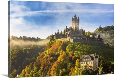 Large Medieval Castle On A Hillside With Fog, Blue Sky, And Cloud, Cochem, Germany