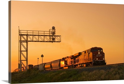 Locomotives Pulling Rail Hopper Cars Pass An Overhead Rail Signal, Alberta, Canada