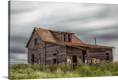 Long exposure of clouds going over an abandoned house, Val Marie, Saskatchewan, Canada