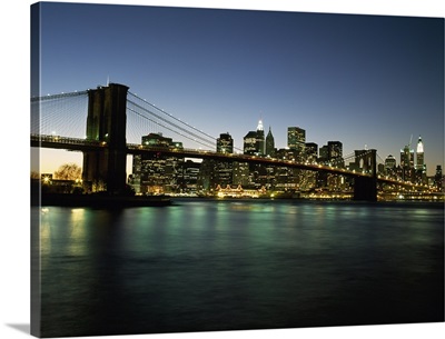 Looking Across The East River And The Brooklyn Bridge At Dusk; New York City, New York