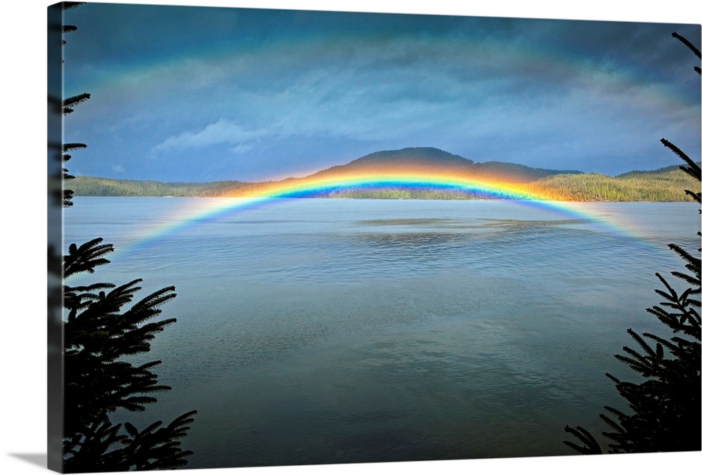 Large landscape photograph of a rainbow over the rippling  waters of Clover Passage, in Ketchikan, Southeast Alaska in ear...