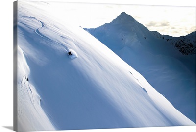 Man Backcountry Skiing In Powder Snow At Wolverine Bowl