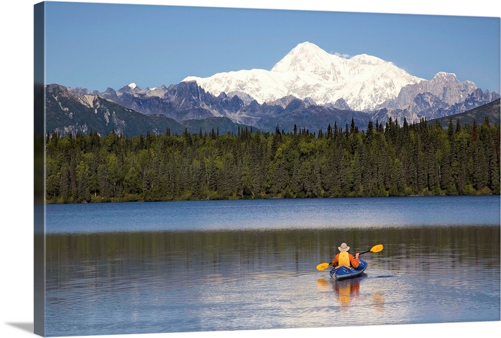A man paddles a Klepper kayak on Byers Lake, Denali State Park, Alaska. Mt. McKinley is in the background. August.