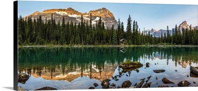 Mountain Range Reflecting In An Alpine Lake With The Glow Of Morning Light, BC, Canada