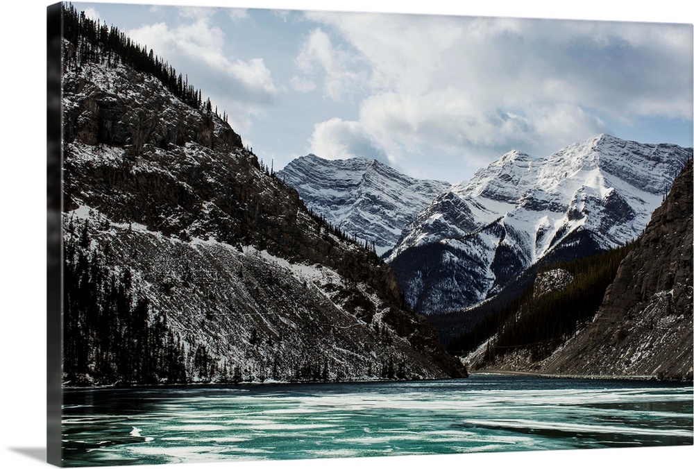 Mountains and frozen lake in winter, Bow Valley Wildland. Alberta, Canada.