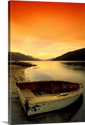 Old Rowboat At Water's Edge With Sunset Background, Alberta, Canada