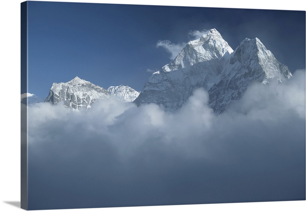 Dramatic peaks of Ama Dablam sunlit above the clouds in the Himalayas of Nepal, Koshi Province, Nepal