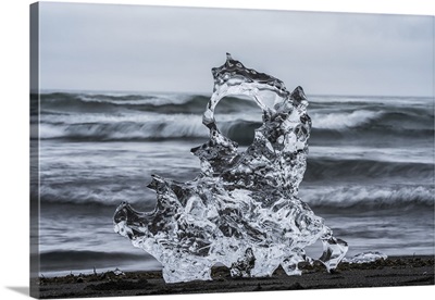 Piece Of Ice On Diamond Beach, Near Jokusarlon, With The Ocean Behind It, Iceland
