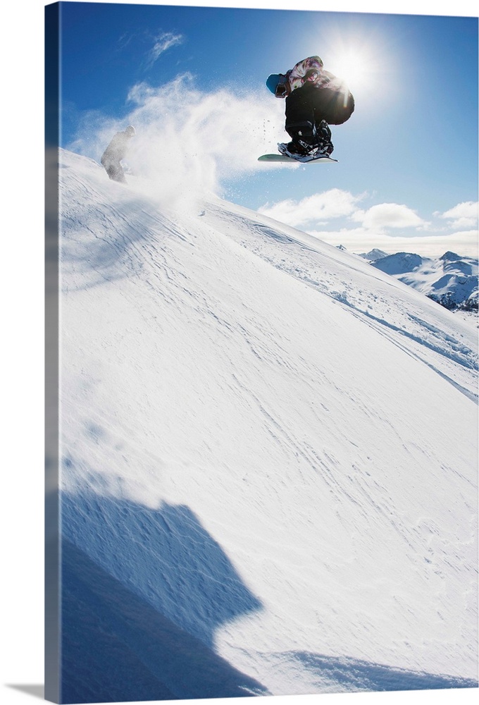 Professional snowboarder making a jump in fresh snow near Ushuaia, Patagonia, Argentina