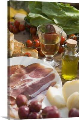 Prosciutto Ham, Cheese, Tomatoes, White Wine And Other Ingredients For A Picnic