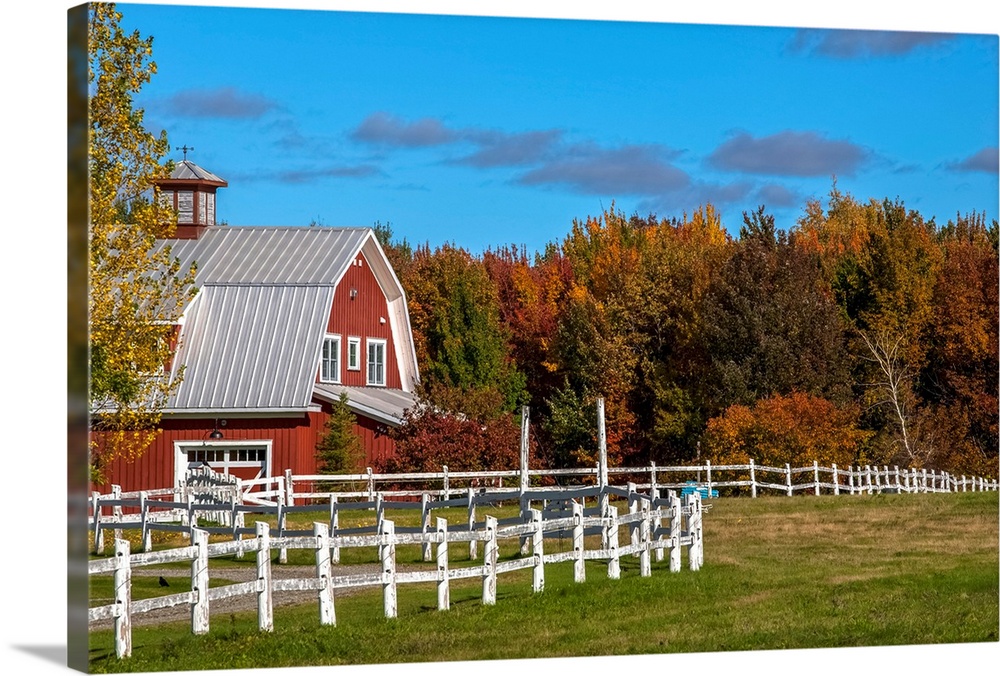 Red barn with trees in autumn colours, Sutton, Quebec, Canada.