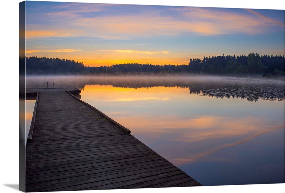Reflection of a beautiful serene sunrise on peaceful Scott lake, Washington, United States of America.