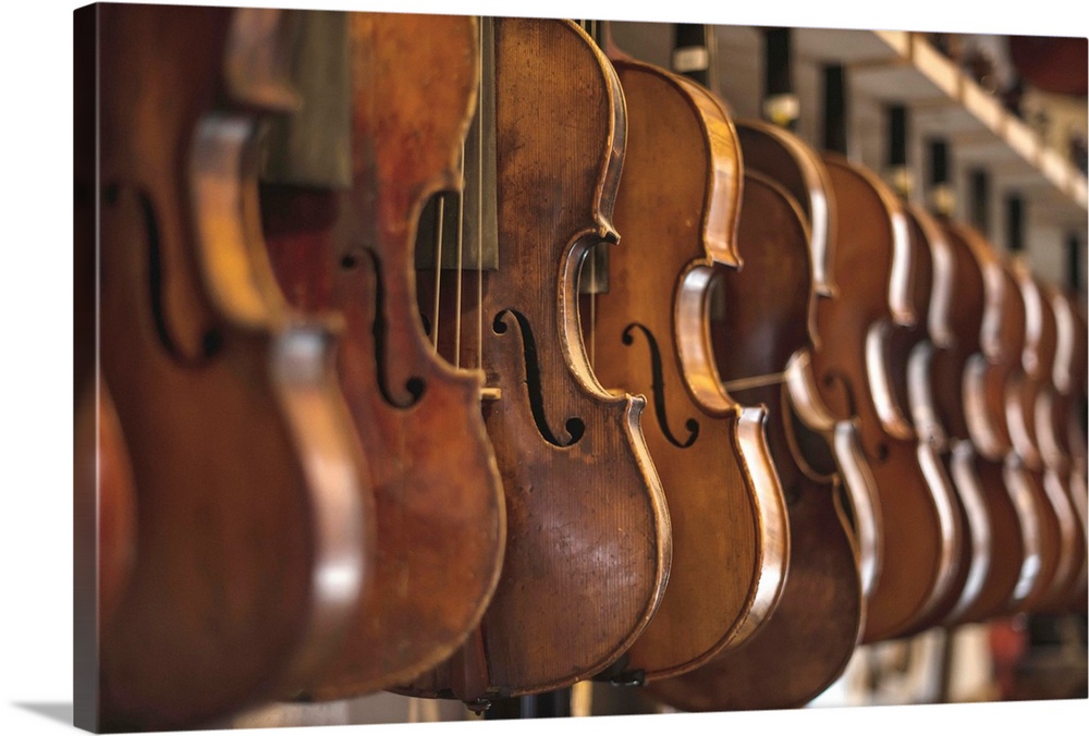 Repaired violins and violas on racks in The Sound Post repair shop, Toronto, Ontario, Canada.