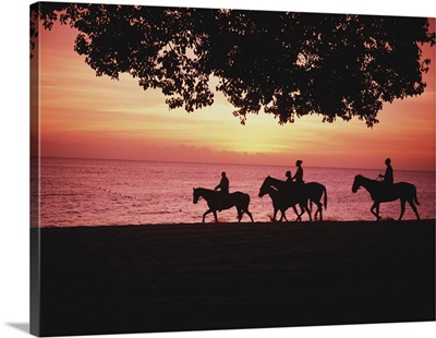 Riding Horses On The Beach At Sunset