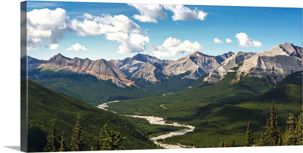 Panorama of river valley and mountain range with blue sky and clouds, Bragg Creek, Alberta, Canada.