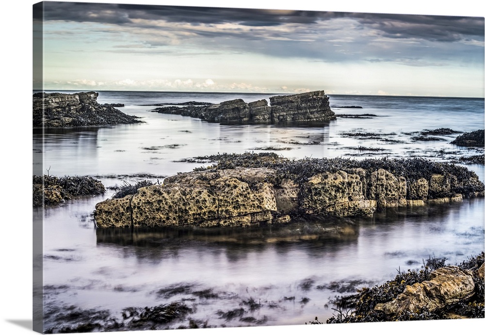 Rocks at low tide at sunset along the coast; Whitburn, Tyne and Wear, England