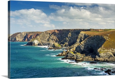 Rocky Cliffs Along The Shoreline With Clouds And Blue Sky, Cornwall County, England