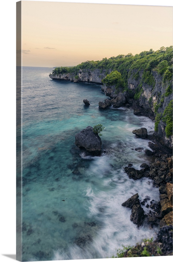 Rugged coastline along an island at twilight. Bira, Sulawesi, Indonesia.