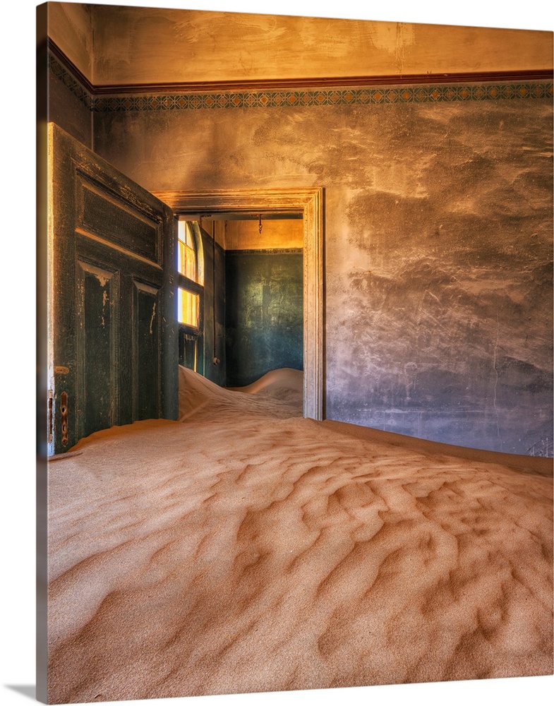 Sand in the rooms of a colourful and abandoned house. Kolmanskop, Namibia.