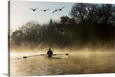 Sculling in mist on River Thames, London, England