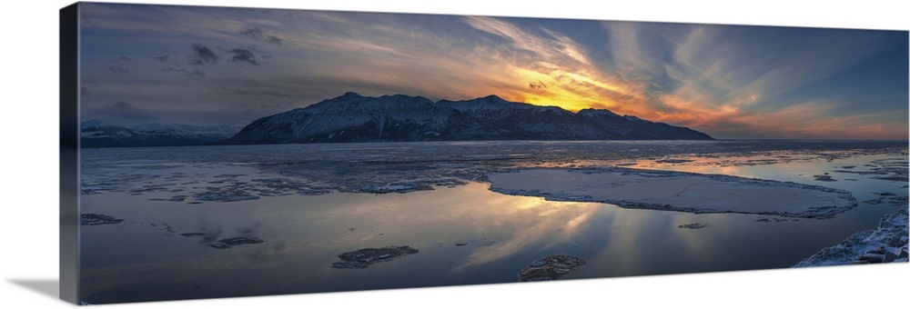 Sheets of ice being carried out with outgoing tide on Turnagain Arm at sunset, south of Anchorage, Alaska.
