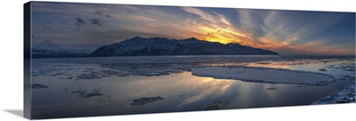 Sheets of ice being carried out with outgoing tide on Turnagain Arm at sunset, Alaska